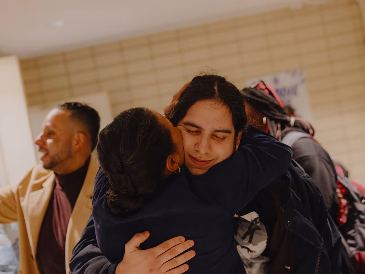 Norma Vega, founding principal at ELLIS Preparatory Academy, center, welcomes Dylan Lopez Contreras, 21, also center, for his first day of school after having spent close to 10 months in Immigration and Customs Enforcement custody.