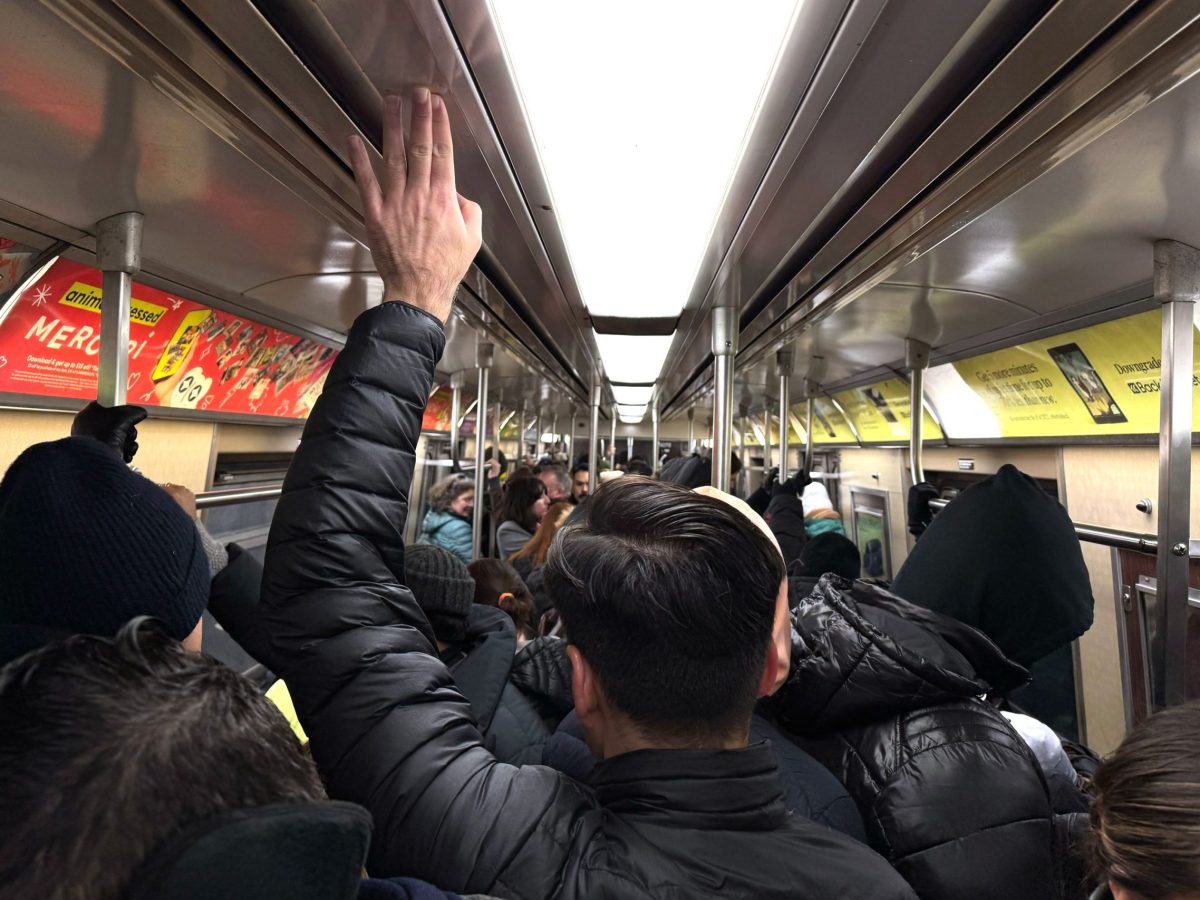 Commuters packed onto an A train during the morning commute.