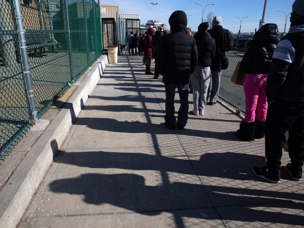 People wait in line to visit loved ones detained on Rikers Island.