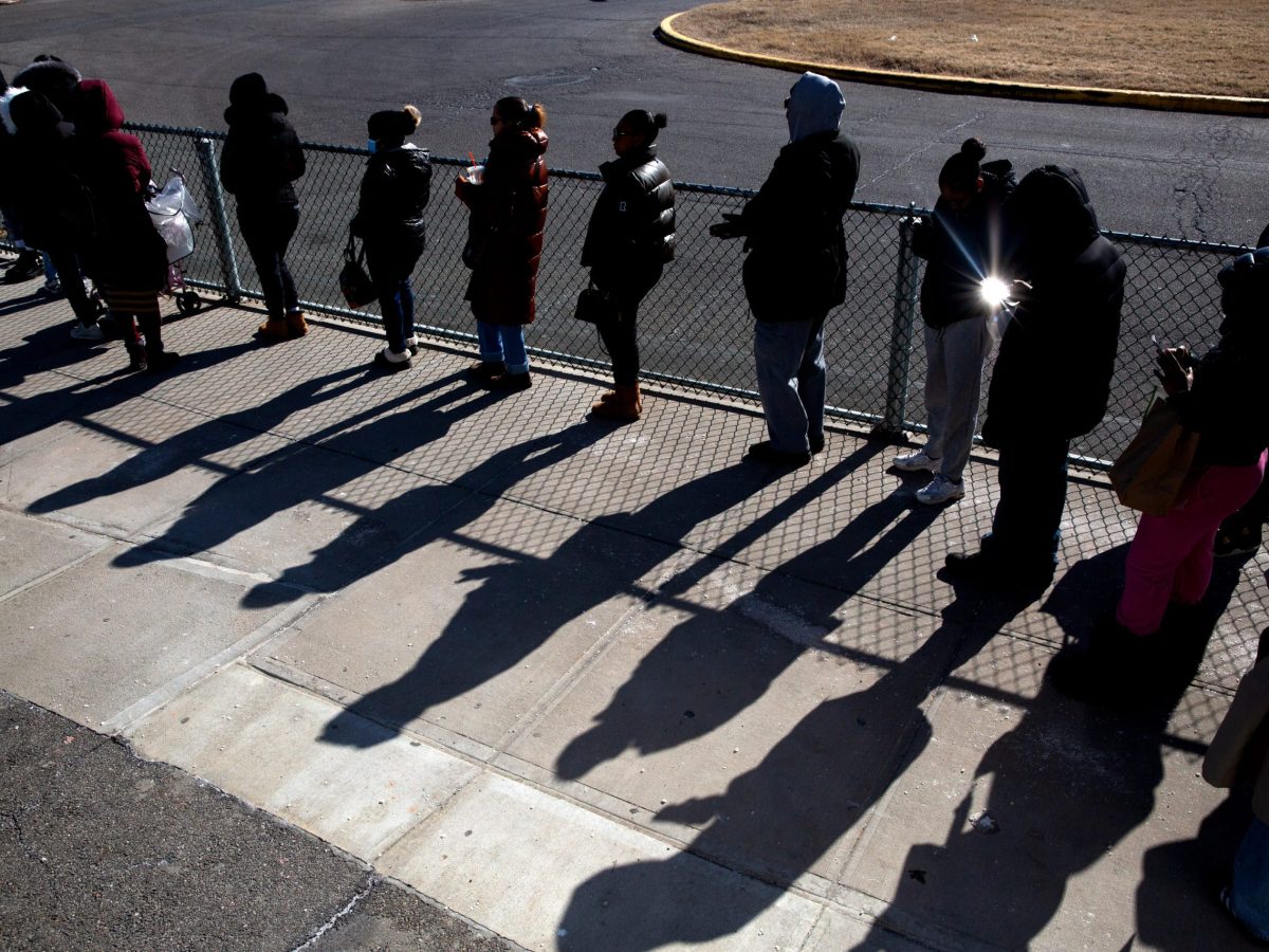 People wait in line to visit loved ones detained on Rikers Island.