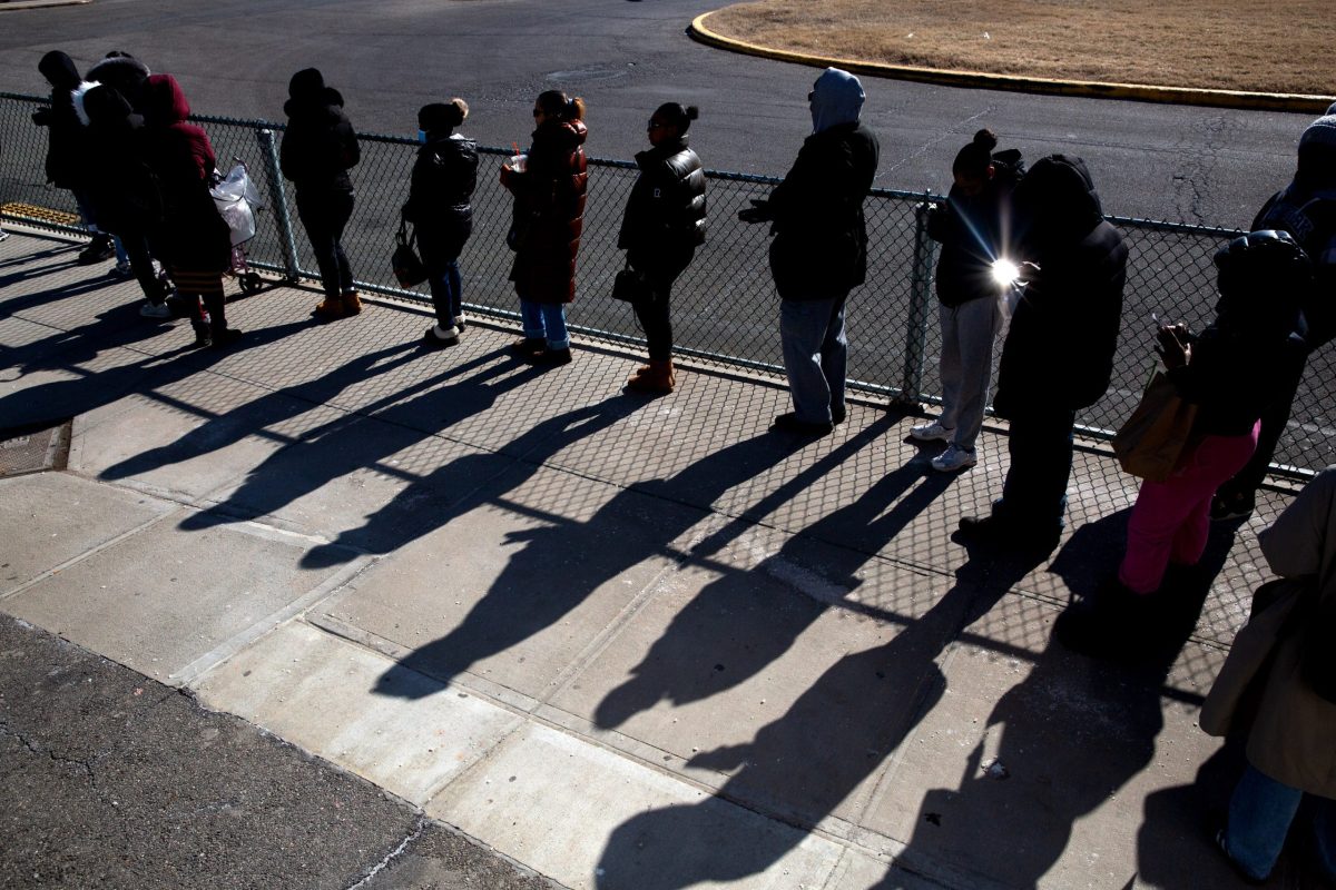 People wait in line to visit loved ones detained on Rikers Island.