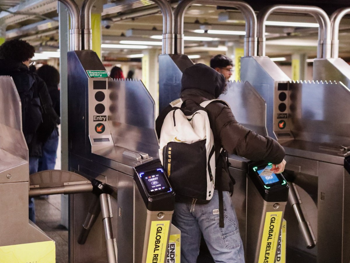 Students use OMNY cards at the 42nd Street station