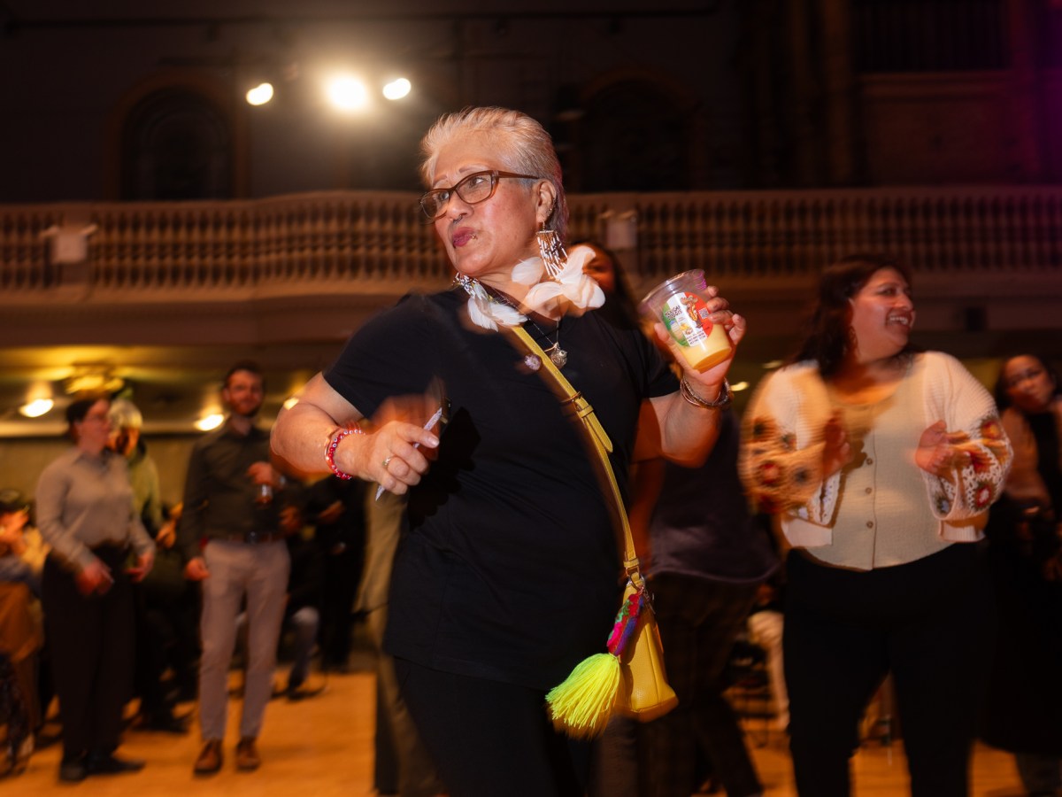 Street vendors dance to live music during a party at Judson Memorial Church in Greenwich Village,