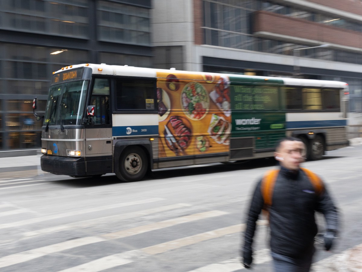 An express bus travels through Lower Manhattan,