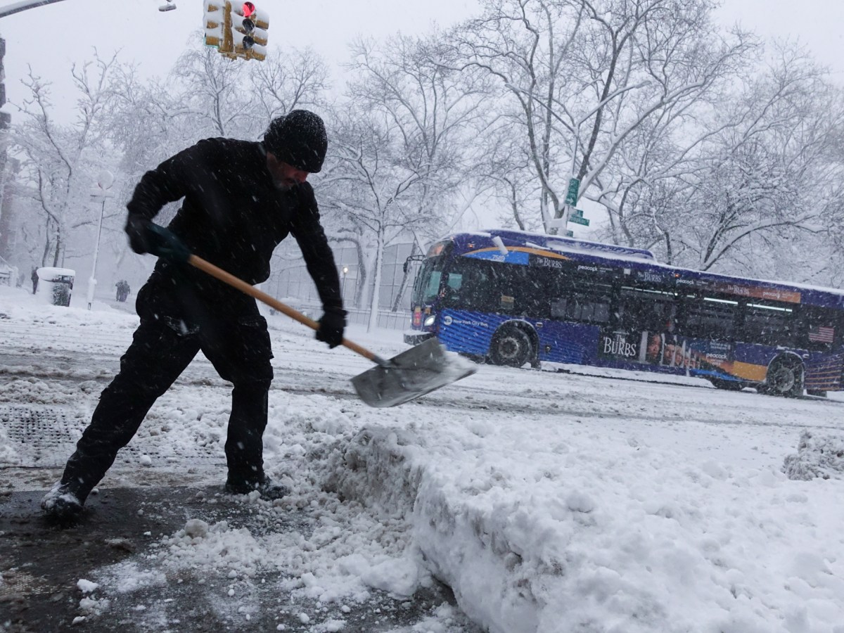 Ricardo Hernandez shovels outside studio where he works in the East village during a blizzard,