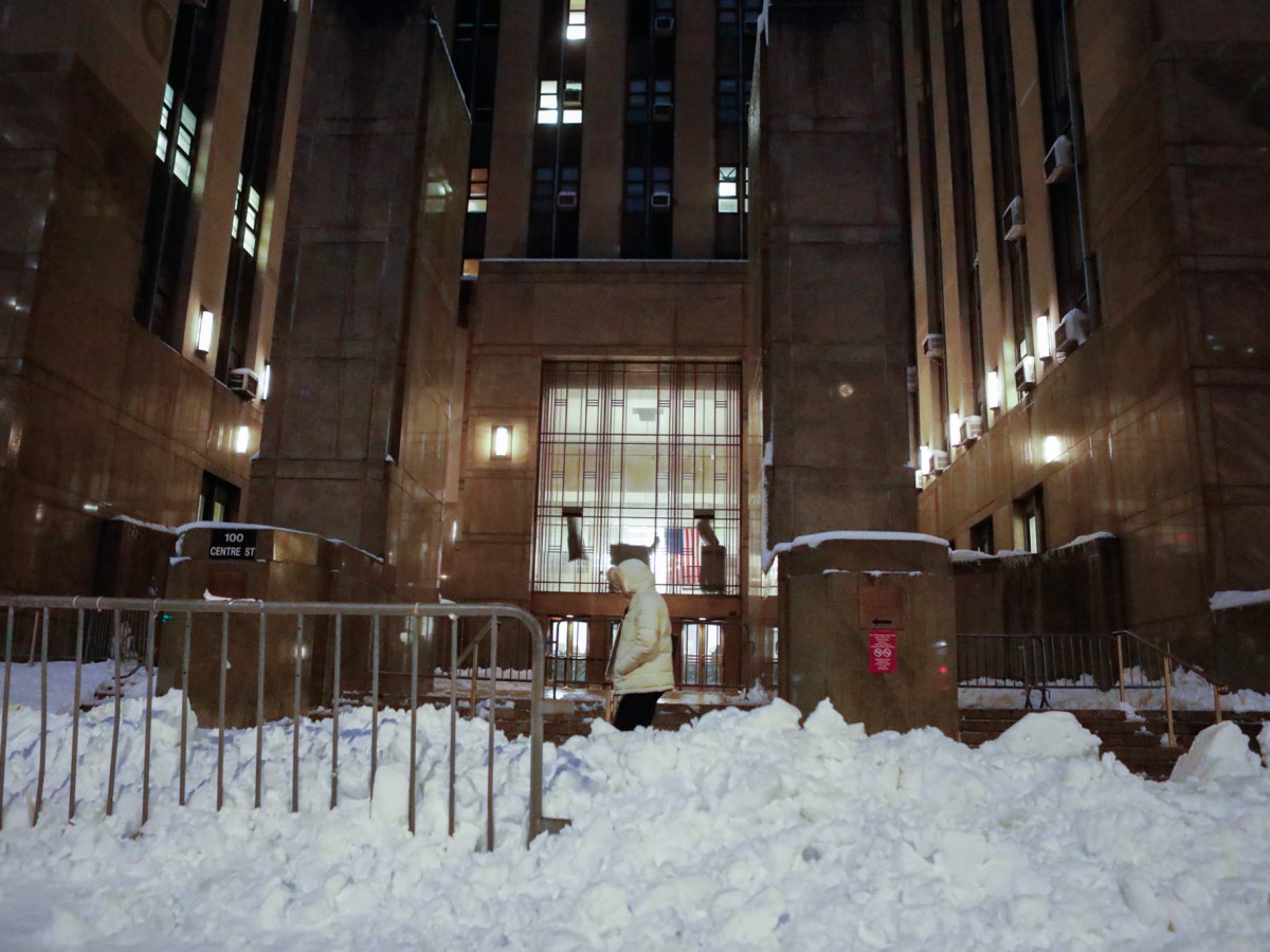 People walk by Manhattan Criminal Court in a blizzard,