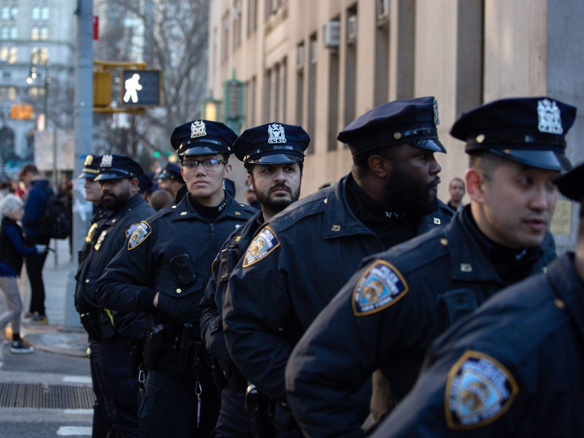 NYPD officers monitor protesters calling for the release of Mahmoud Khalil march up Centre Street.