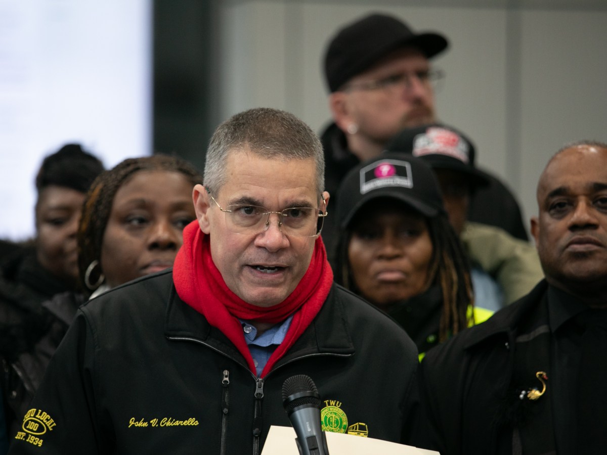 TWU Local 100 President John Chiarelllo speaks alongside union members outside the Jay Street Metro-Tech Station about MTA plans to reduce station agents,