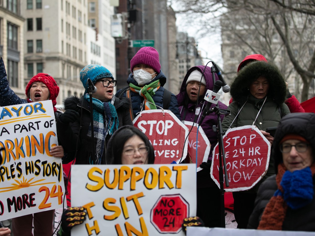 Home health aides rally before starting a sit-in outside City Hall to demand the passage of a bill ending 24-hour shifts