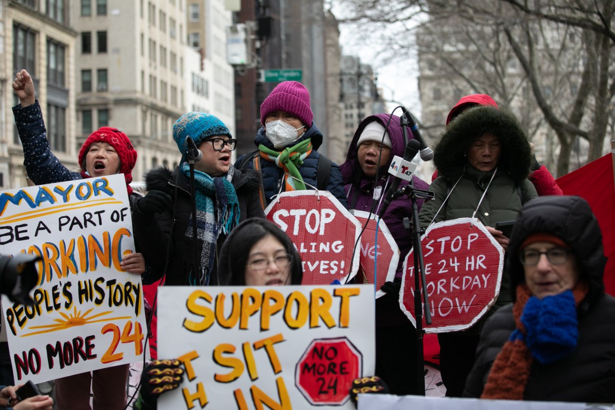 Home health aides rally before starting a sit-in outside City Hall to demand the passage of a bill ending 24-hour shifts