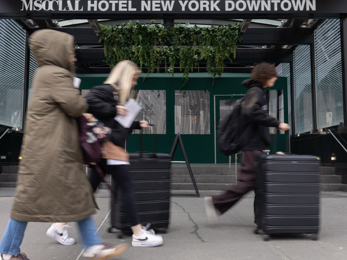 Lower Manhattan hotel guests rush to catch a cab,