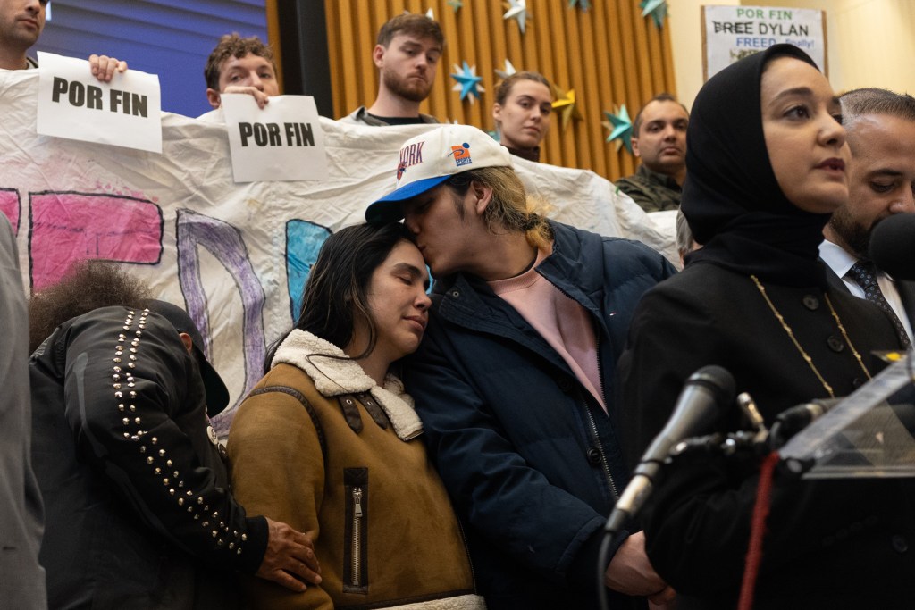 High school student Dylan Lopez Contreras kisses his mother at an East Village church after spending 10 months in immigration detention,