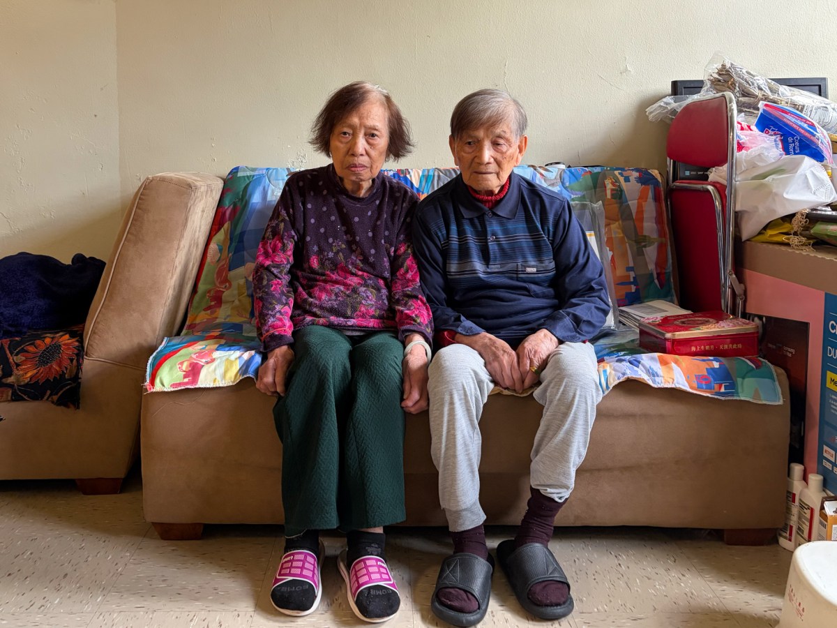 90-year-old Qiong Zhong and her 93-year-old husband Jin Tao Wu sit in their Chelsea Addition NYCHA apartment