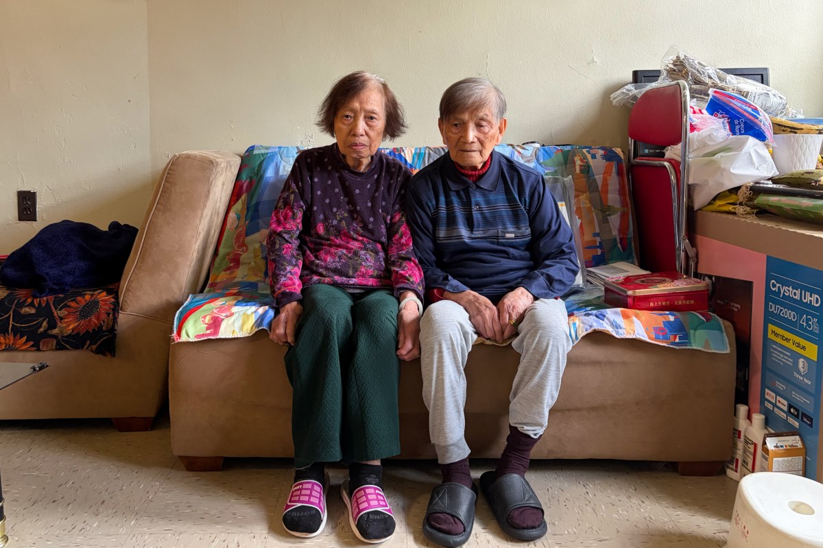 90-year-old Qiong Zhong and her 93-year-old husband Jin Tao Wu sit in their Chelsea Addition NYCHA apartment