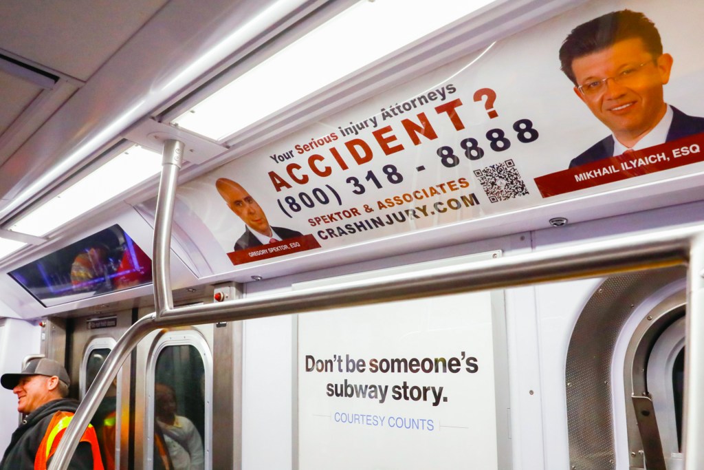 Personal injury lawyers advertise on a C train,