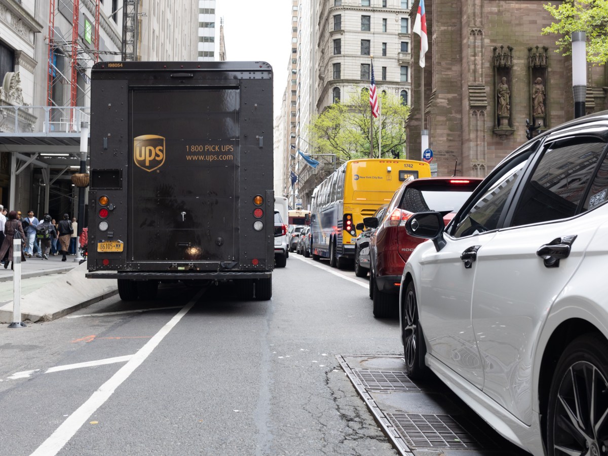 A UPS truck blocks broadway in Lower Manhattan, forcing traffic into the bus lane,