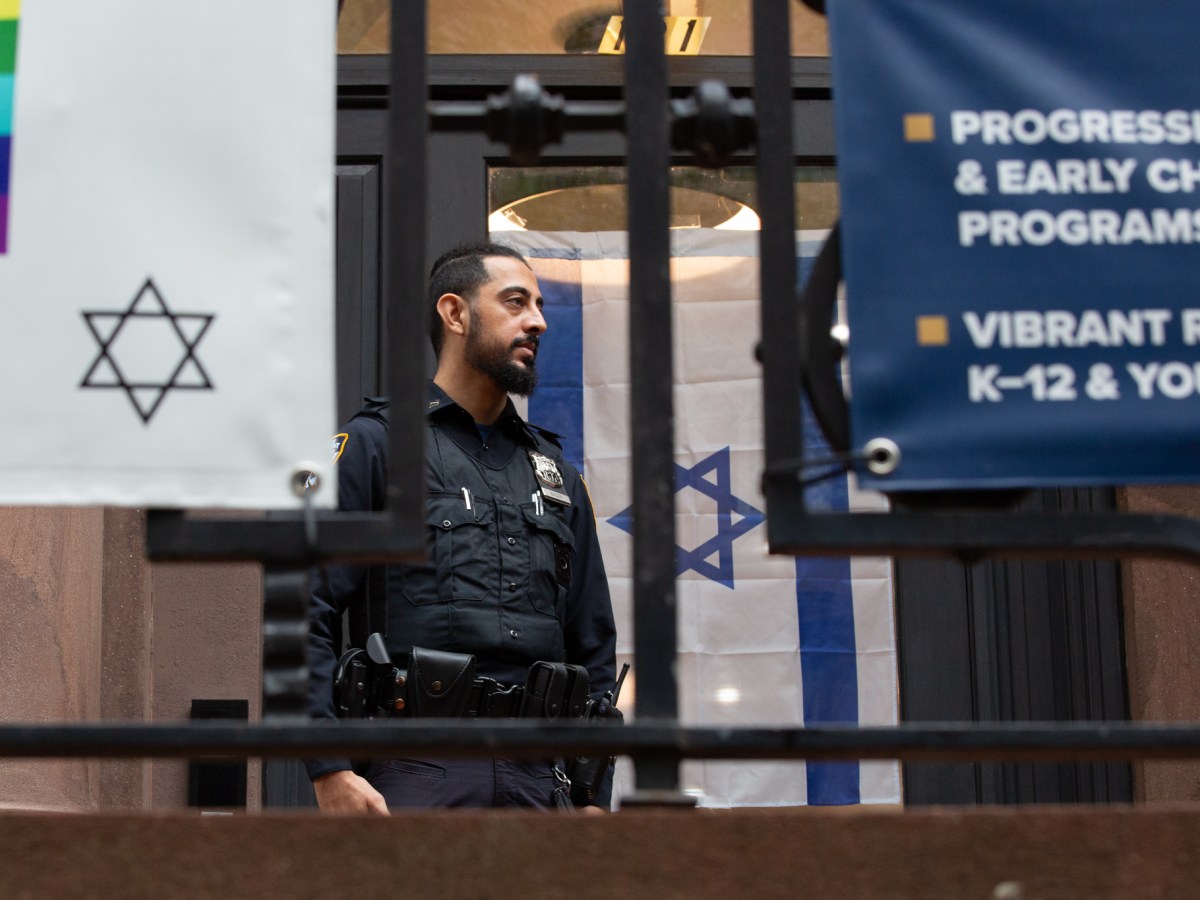 An NYPD officer stands guard outside a Synagogue in Brooklyn Heights.