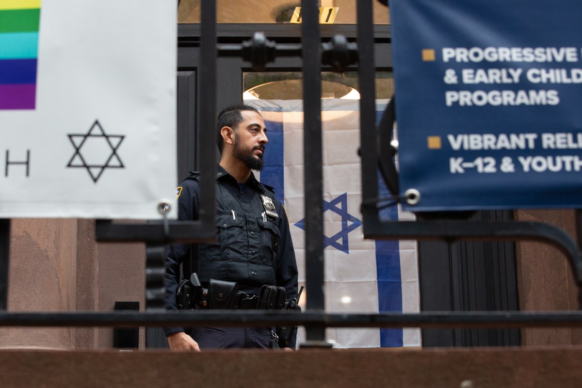 An NYPD officer stands guard outside a Synagogue in Brooklyn Heights.