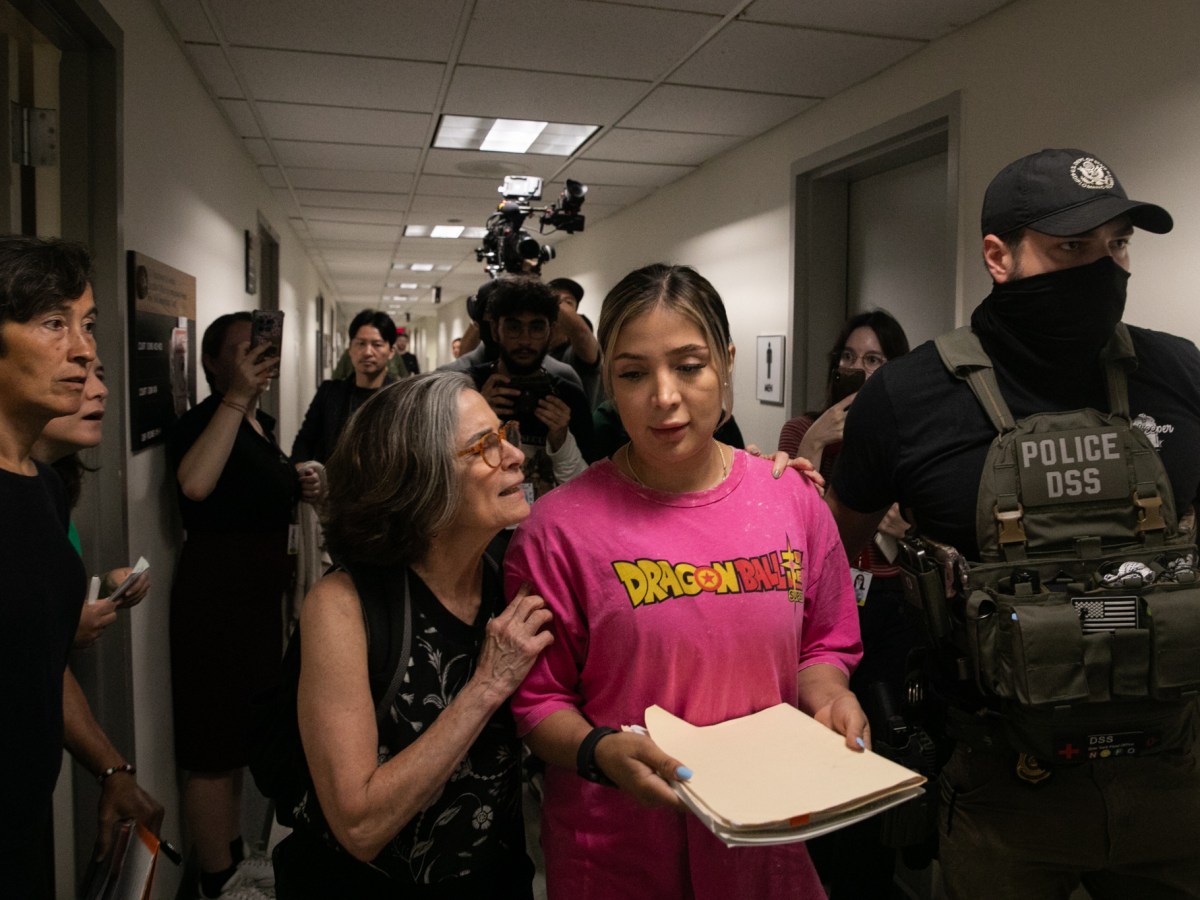 A court observer tries to comfort a woman who was detained by federal agents after her immigration hearing inside 26 Federal Plaza.