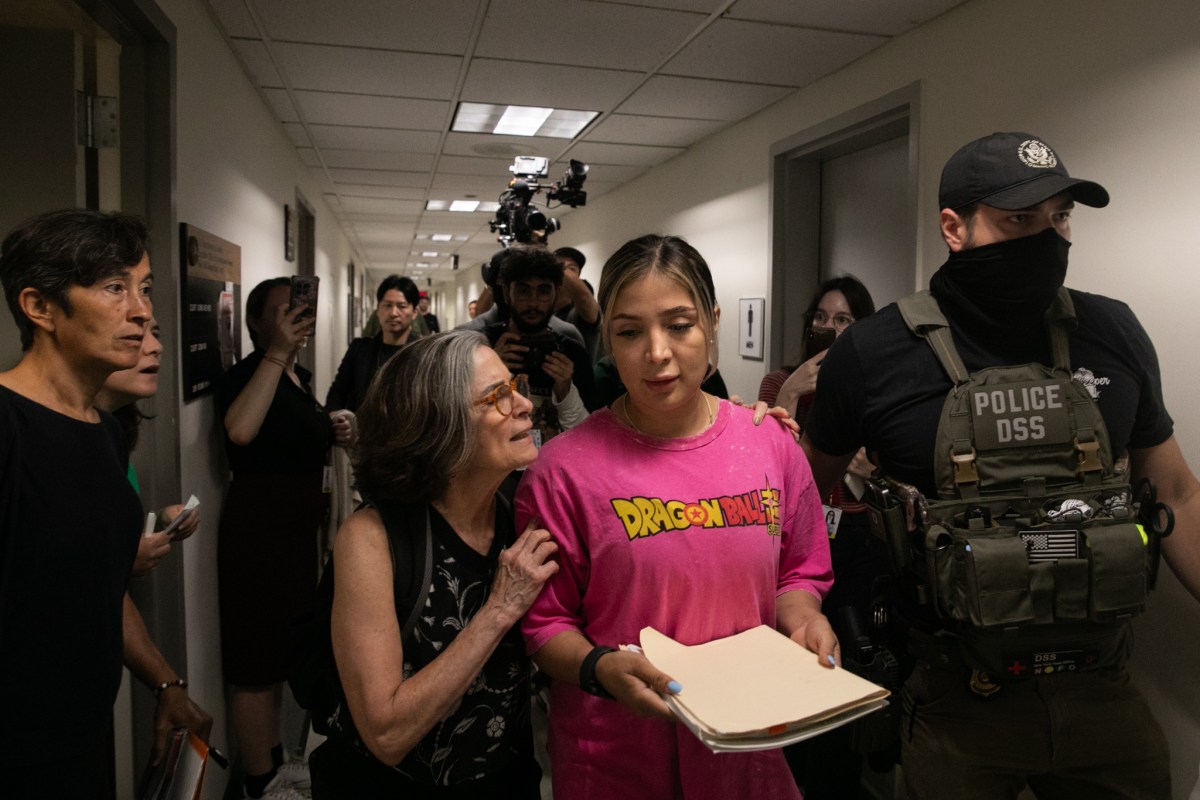 A court observer tries to comfort a woman who was detained by federal agents after her immigration hearing inside 26 Federal Plaza.