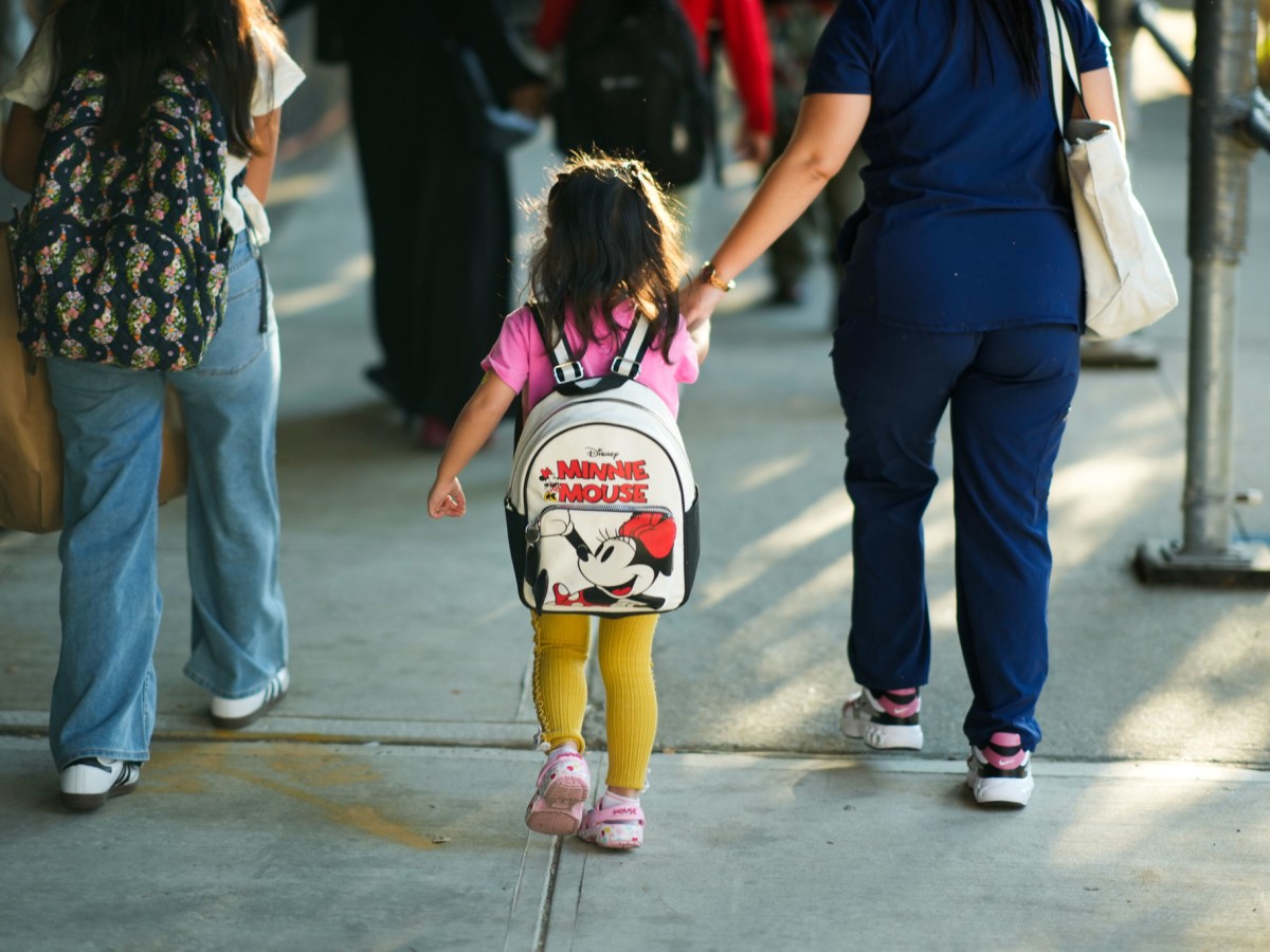 Parents walk their children to class in Queens on the first day of school,