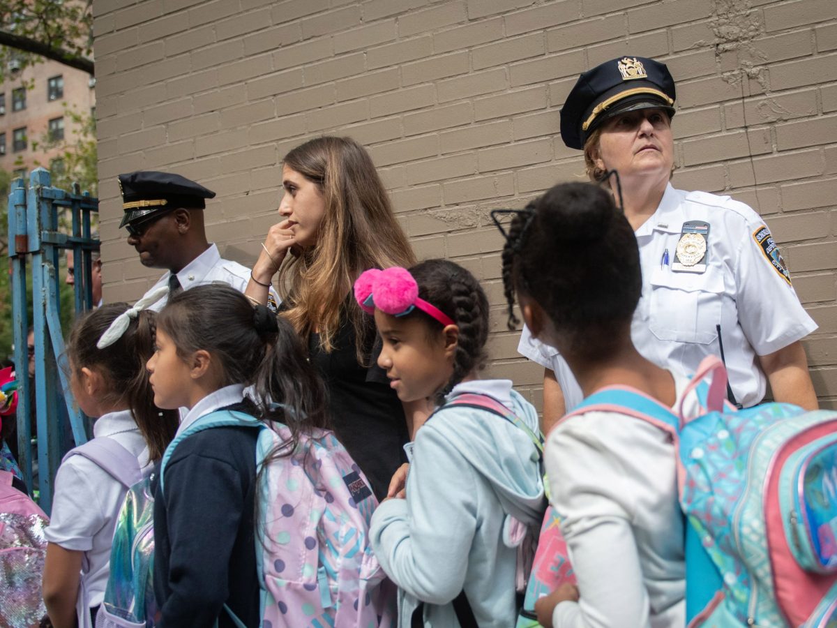 School safety officers greet students outside P.S. 146 in Manhattan after their first day of the classes