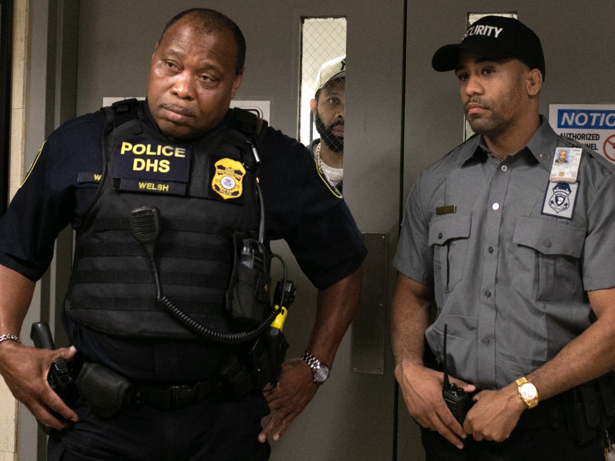 Federal agents block a door to an immigrant-detention center inside 26 Federal Plaza,