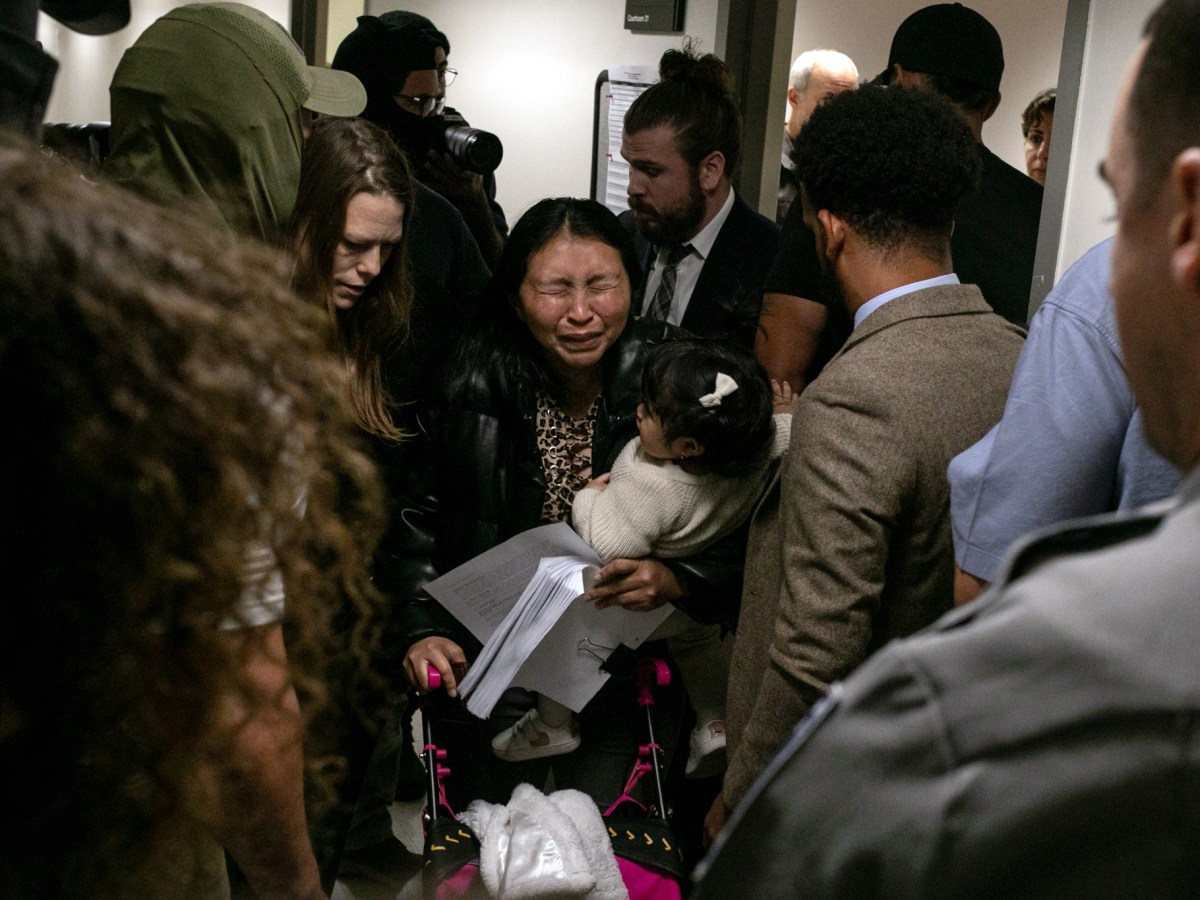A mother was overcome with emotion after immigration agents detained her partner following a court hearing inside 26 Federal Plaza.