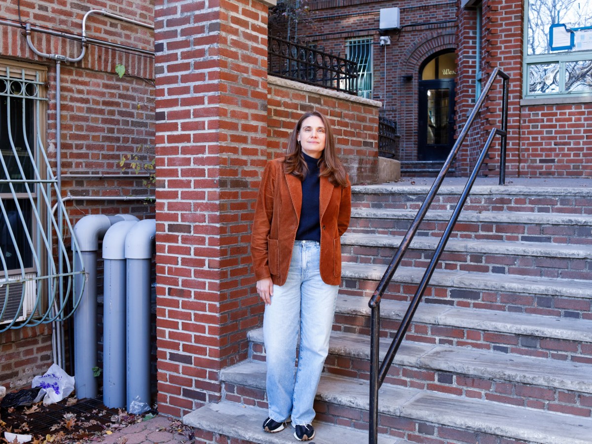Samantha Magistro poses for a portrait in front of an affordable residential building she manages in The Bronx