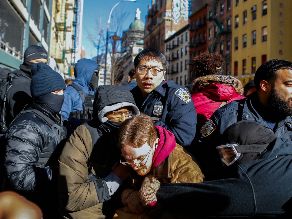 Federal agents clash with dozens of protesters outside a General Services Administration garage near Canal Street ahead of an expected immigration raid