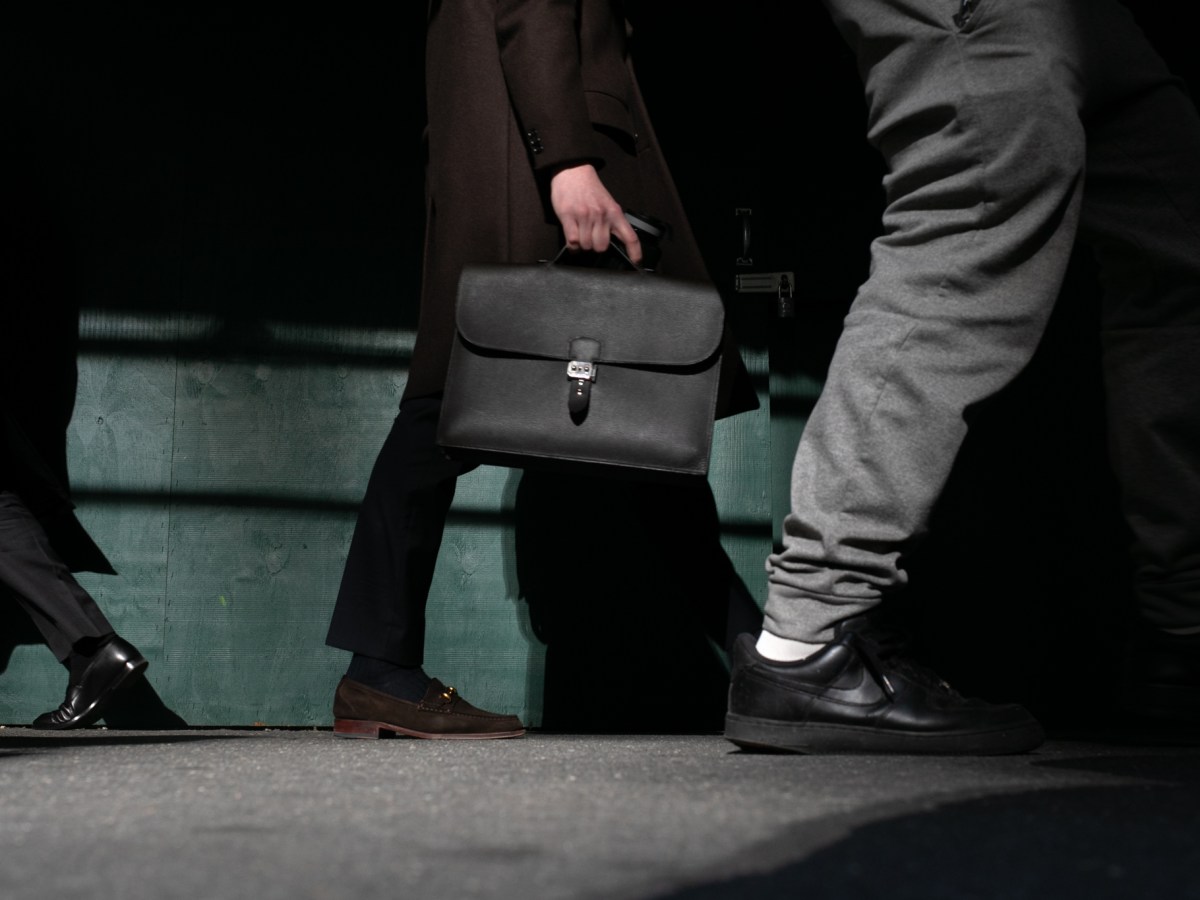 Workers stroll down Wall Street near the Stock Exchange,