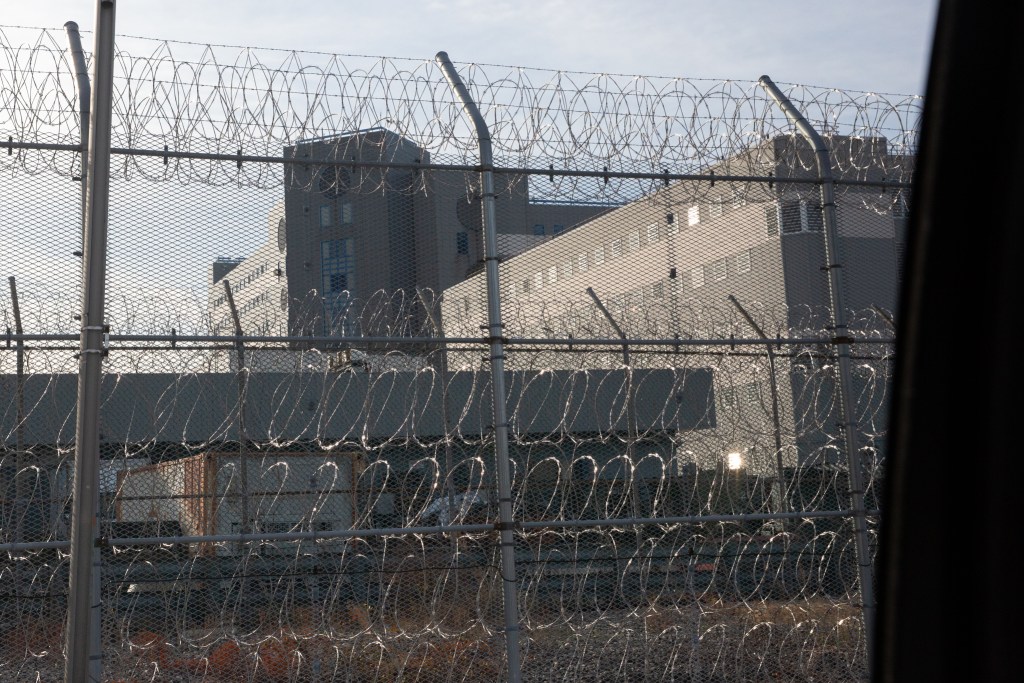Barbed wire surrounds a jail facility on Rikers Island,
