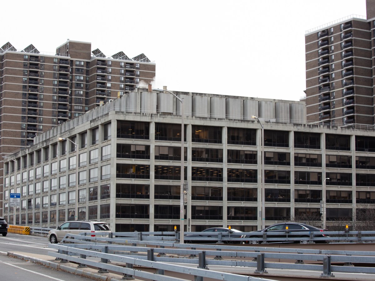 The concrete brutalist office building at 100 Gold Street was visible from the Brooklyn Bridge overpass