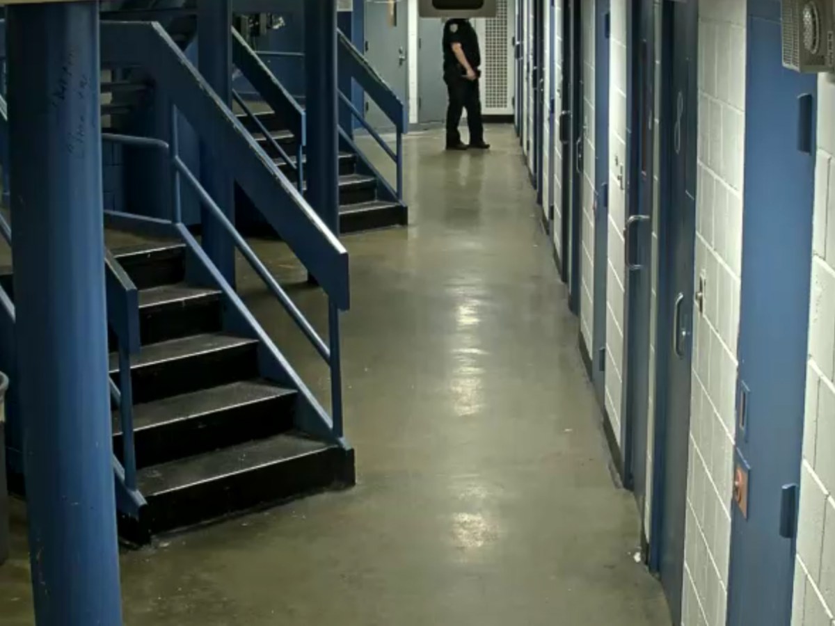 A correction officer walks past a cell in the former Manhattan Detention Complex where a detainee was allegedly being sexually assaulted in 2019.