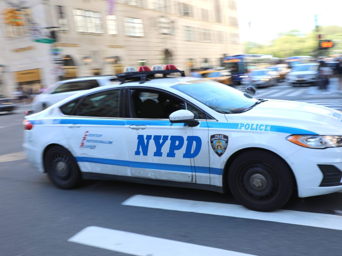 An NYPD officer drives through Manhattan