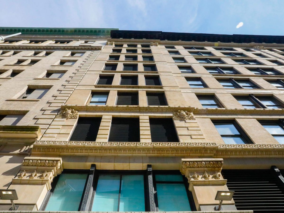 The Triangle Shirtwaist Factory building from below. Looking up at boarded up windows.